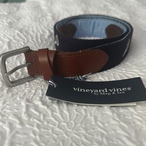 Vineyard Vines Navy Belt with Brown Leather with pickleballs and paddles.